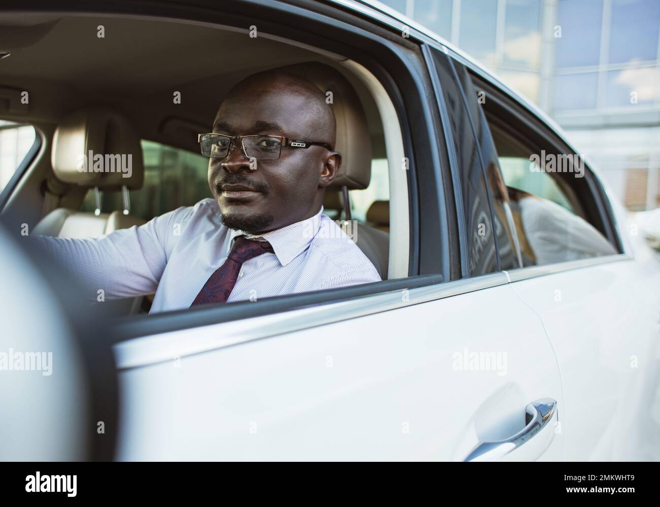 Portrait of a handsome successful African American businessman driving his car Stock Photo