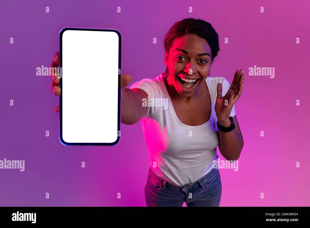 Amazing Offer. Excited Black Woman Showing Blank Smartphone At Camera Stock Photo
