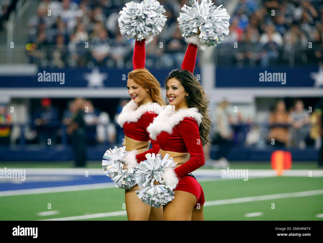 The Dallas Cowboys Cheerleaders wear a holiday costume as they perform