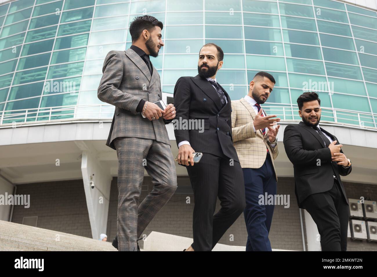 Business people outdoor meeting. A group of male businessmen in suits ...