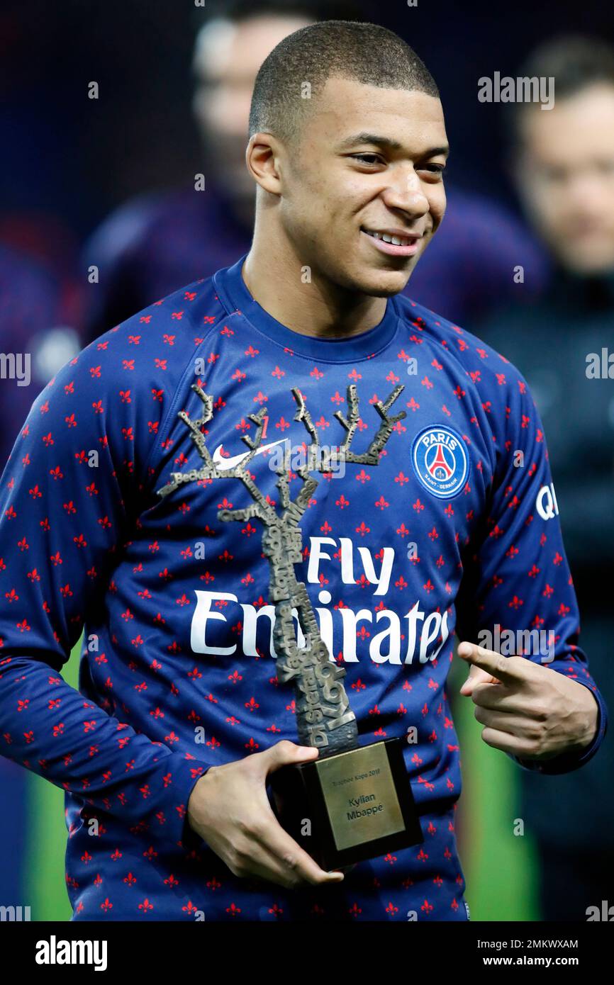 Paris St Germain's Kylian Mbappe poses and celebrates with the Kopa Trophy  of the Golden Ball, "Ballon d'Or" award prior to the League One soccer  match between Paris Saint Germain and Nantes