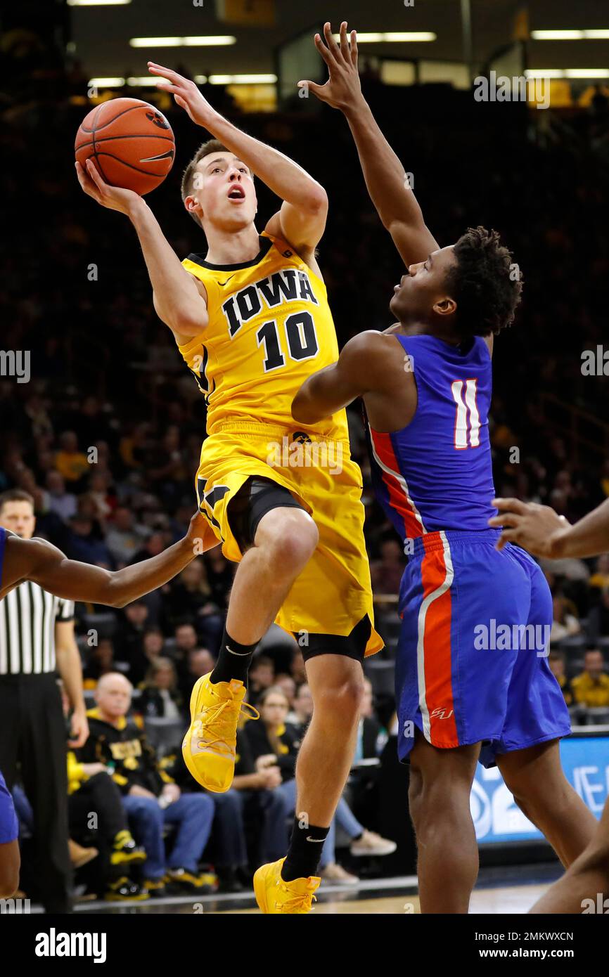 Iowa guard Joe Wieskamp (10) is fouled by Savannah State guard Jaquan  Dotson (11) while driving to the basket during the second half of an NCAA  college basketball game, Saturday, Dec. 22,