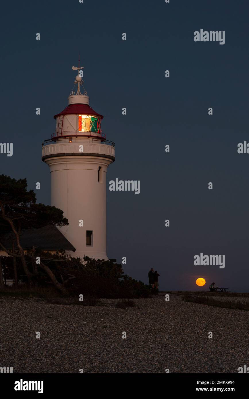 Full moon rising over Sletterhage lighthouse on, Djursland, Jutland, Denmark Stock Photo