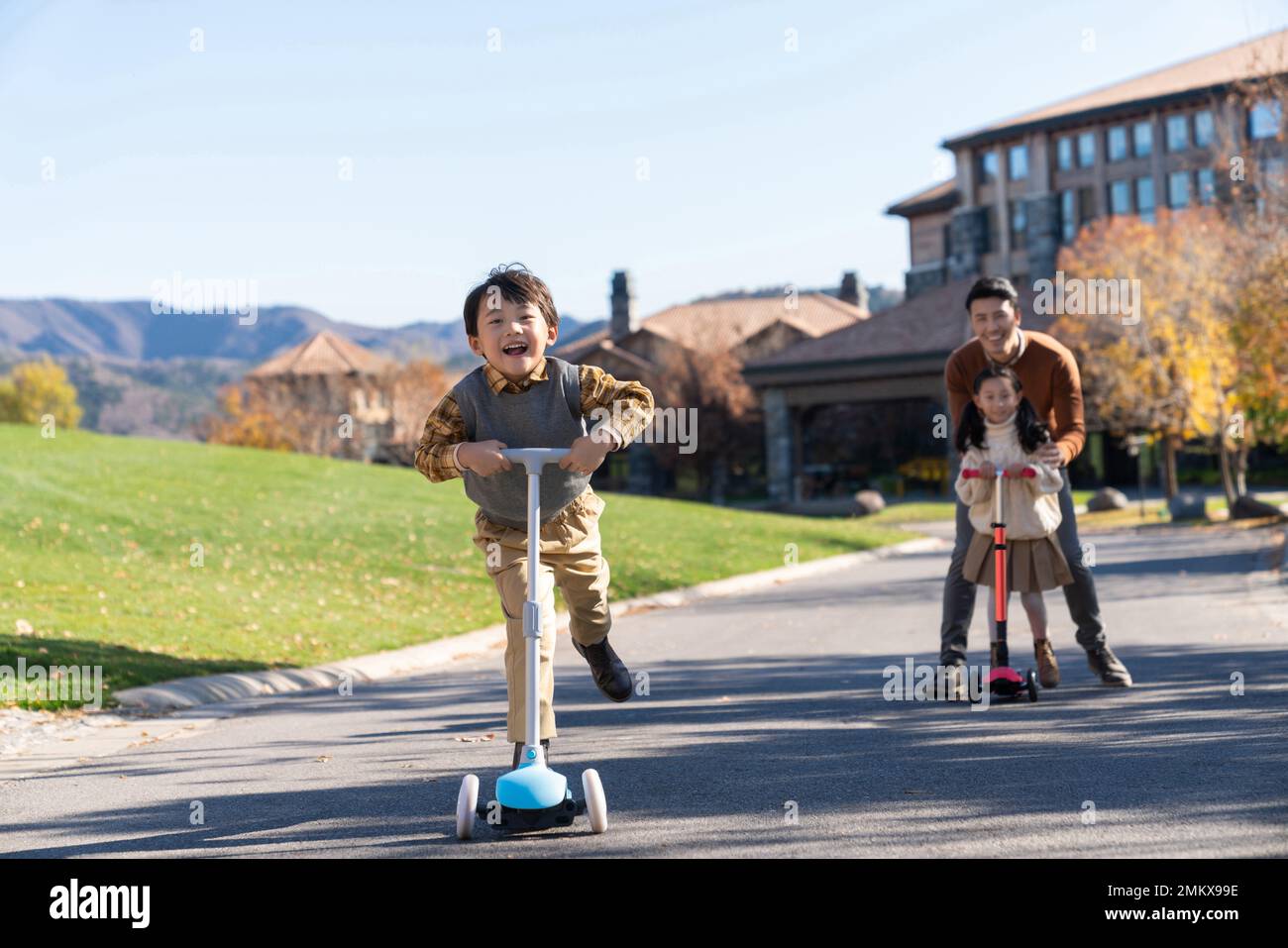 Father took the children to play in the scooter Stock Photo