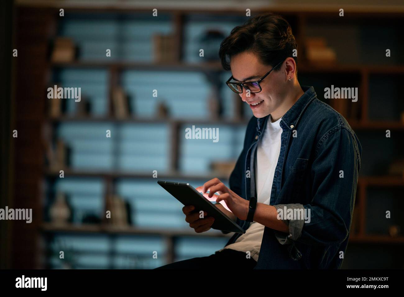 Smiling young man professional holding using digital tablet at office Stock Photo