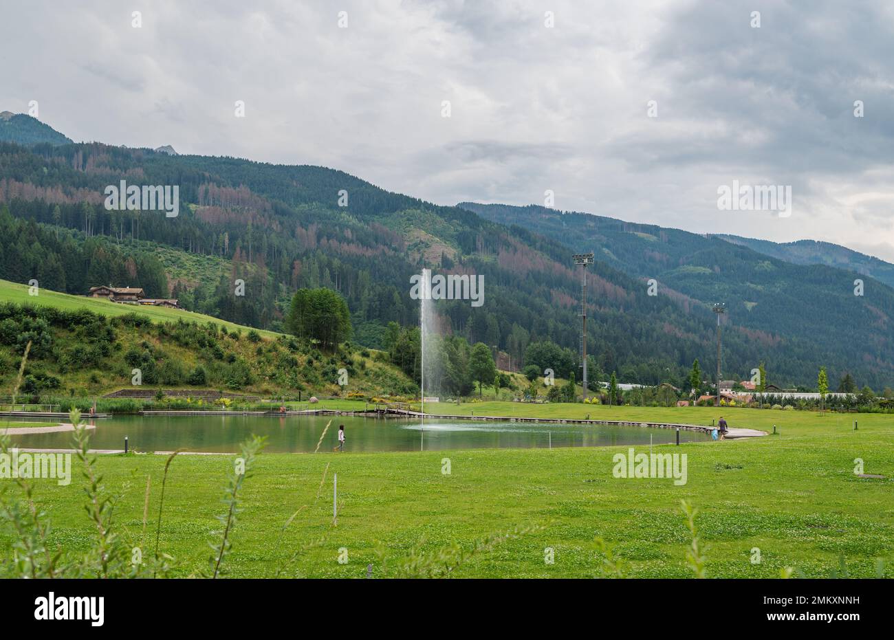 Predazzo bio-lake: a green area of the town. Includes a skate park and playground with the presence of purifying water plants -  Fiemme Valley in Tren Stock Photo