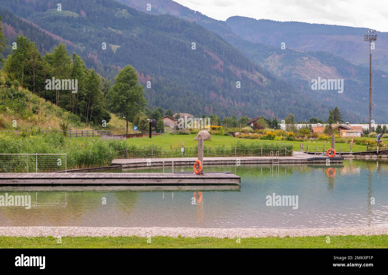 Predazzo bio-lake: a green area of the town. Includes a skate park and playground with the presence of purifying water plants -  Fiemme Valley in Tren Stock Photo