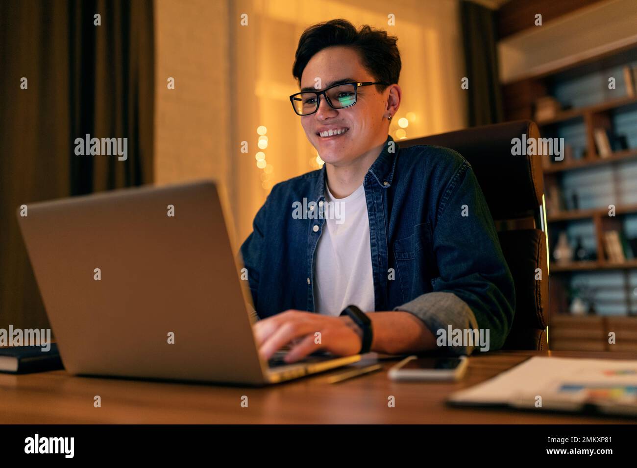Handsome young happy IT specialist working on computer at office Stock Photo