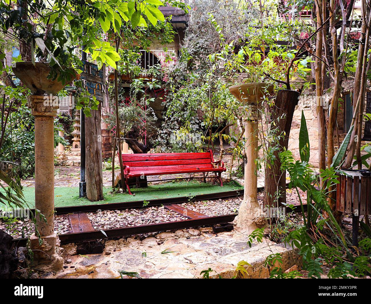 Red vintage bench and decorative rails in Al Muna park. Druze village Julis in Israel. Stock Photo