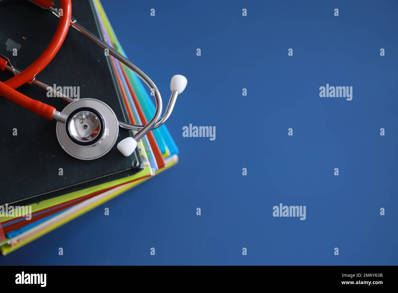 stethoscope on stack of medical guide book for doctor learning ...