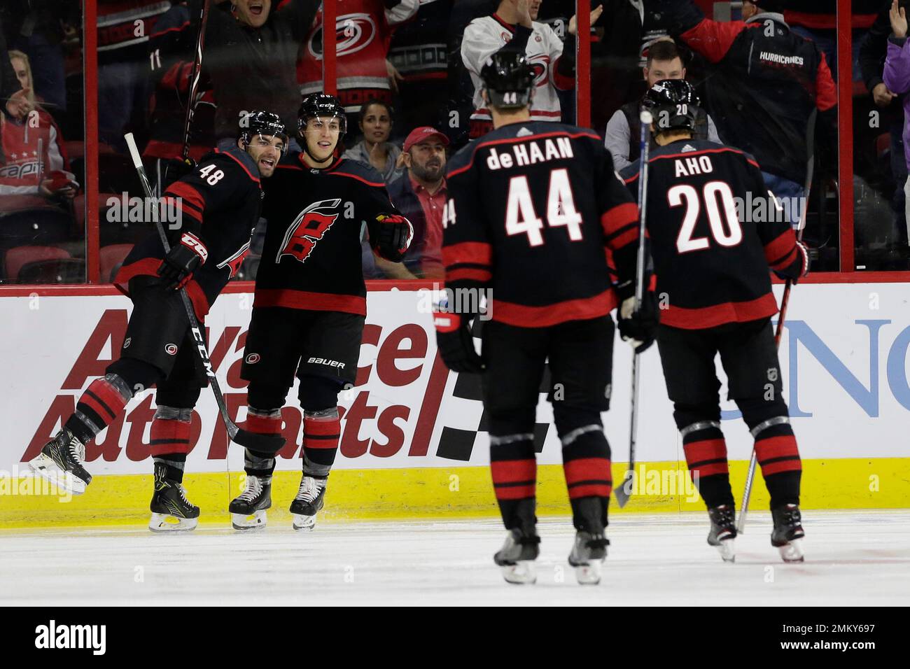 Carolina Hurricanes' Jordan Martinook (48) celebrates his goal with  teammates Jordan Staal (11) and Jesper Fast (71) during the first period of  an NHL hockey game against the Detroit Red Wings in