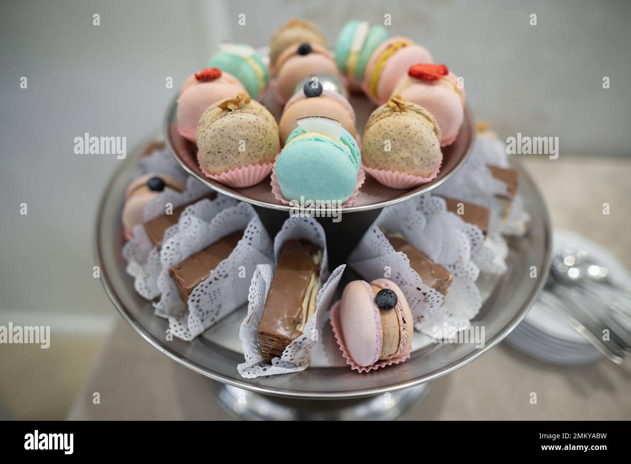 various delicious macaron cookies on a round stand tray Stock Photo