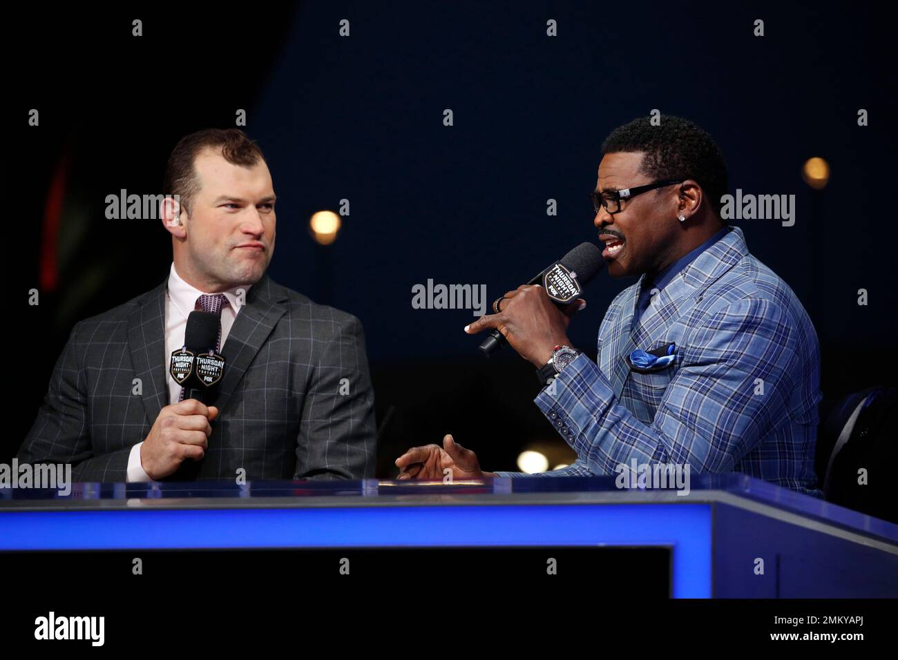 Commentators Joe Hayden Thomas and Mike Irvin, right, work in the Thursday Night Football set