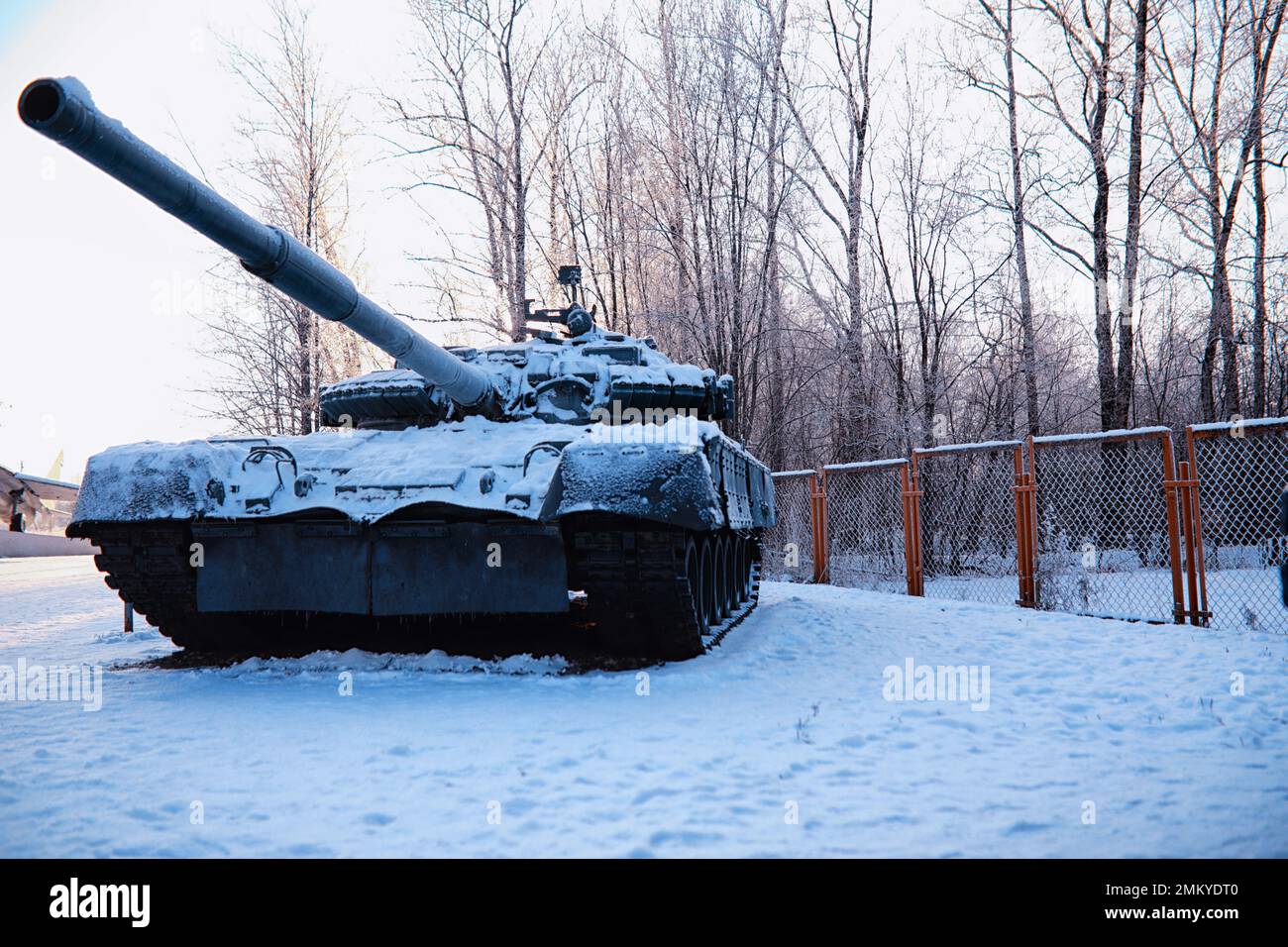 Military tank in a row. Battle tank in the snow on the roadside of ...