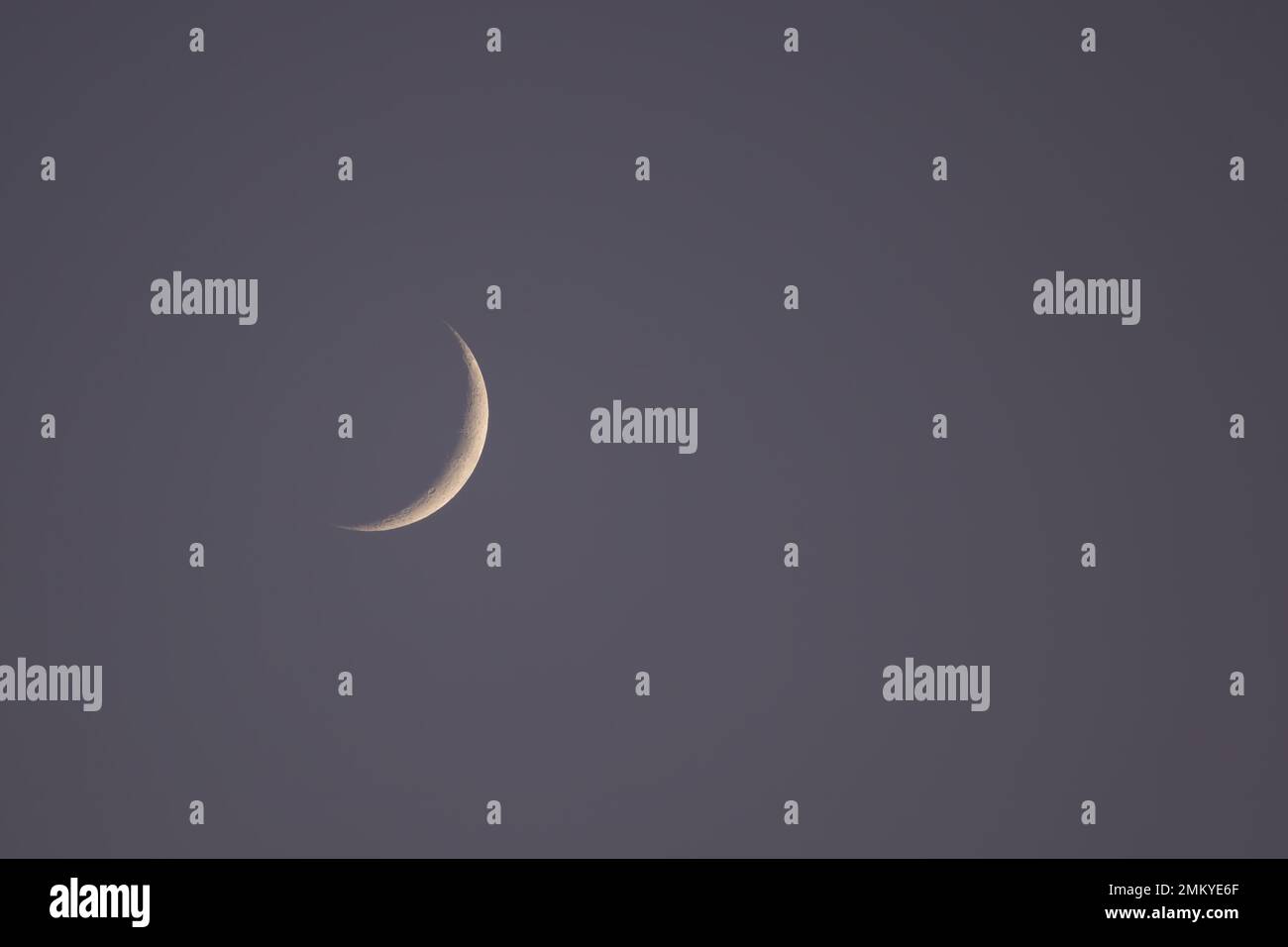 Waxing Crescent Moon in early evening sky in January 2022 Stock Photo