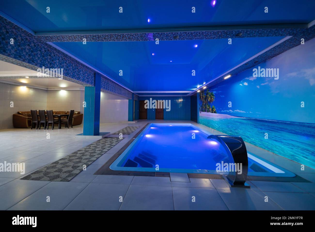 a modern large indoor pool with blue lighting and a waterfall Stock ...