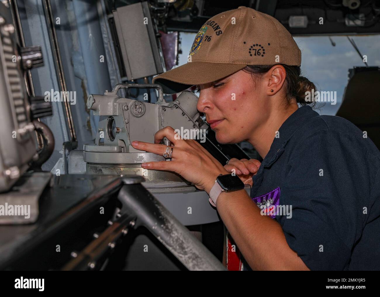 SOUTH CHINA SEA (Sept. 12, 2022) Ensign Jackie Wrage, from New Port Richey, Florida, uses a telescopic alidade located on the bridge aboard Arleigh Burke-class guided-missile destroyer USS Higgins (DDG 76) while conducting a replenishment-at-sea in the South China Sea, Sept. 12. Higgins is assigned to Commander, Task Force 71/Destroyer Squadron (DESRON) 15, the Navy's largest forward-deployed DESRON and the U.S. 7th fleet's principal surface force. Stock Photo