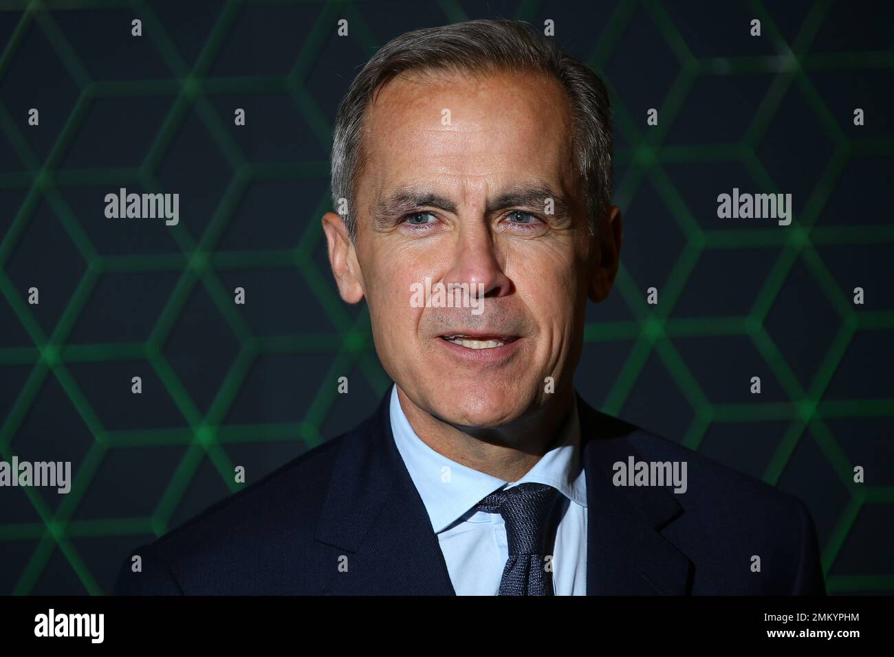 Mark Carney poses for photographers upon arrival at the Bloomberg and