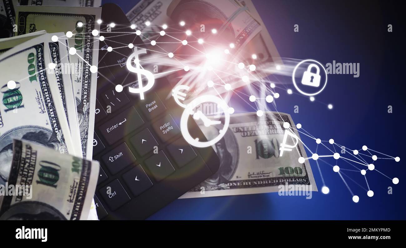Computer keyboard and a scattering of 100 dollar bills on the table ...