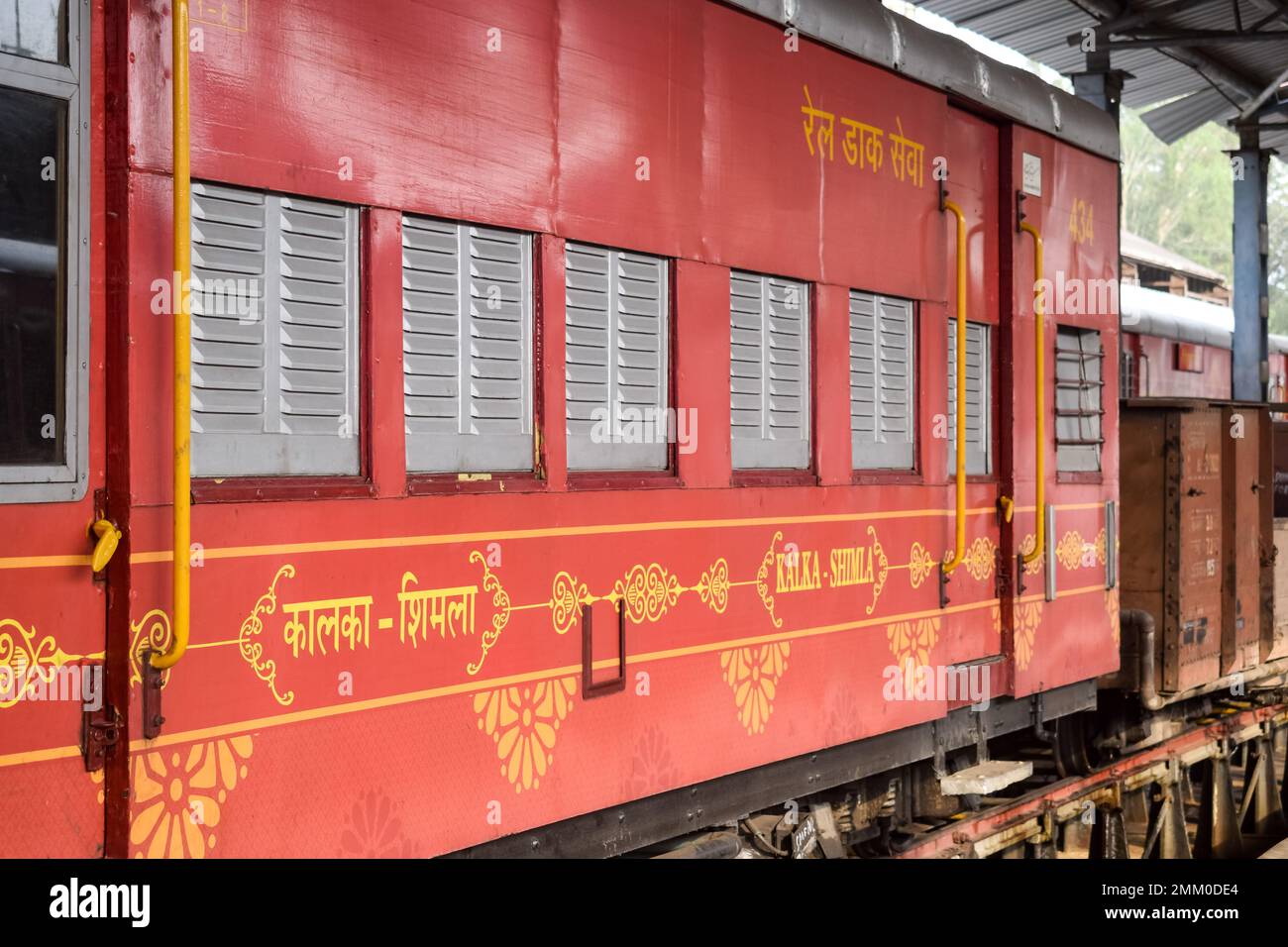 View of Toy train coach from the middle of railway track during daytime