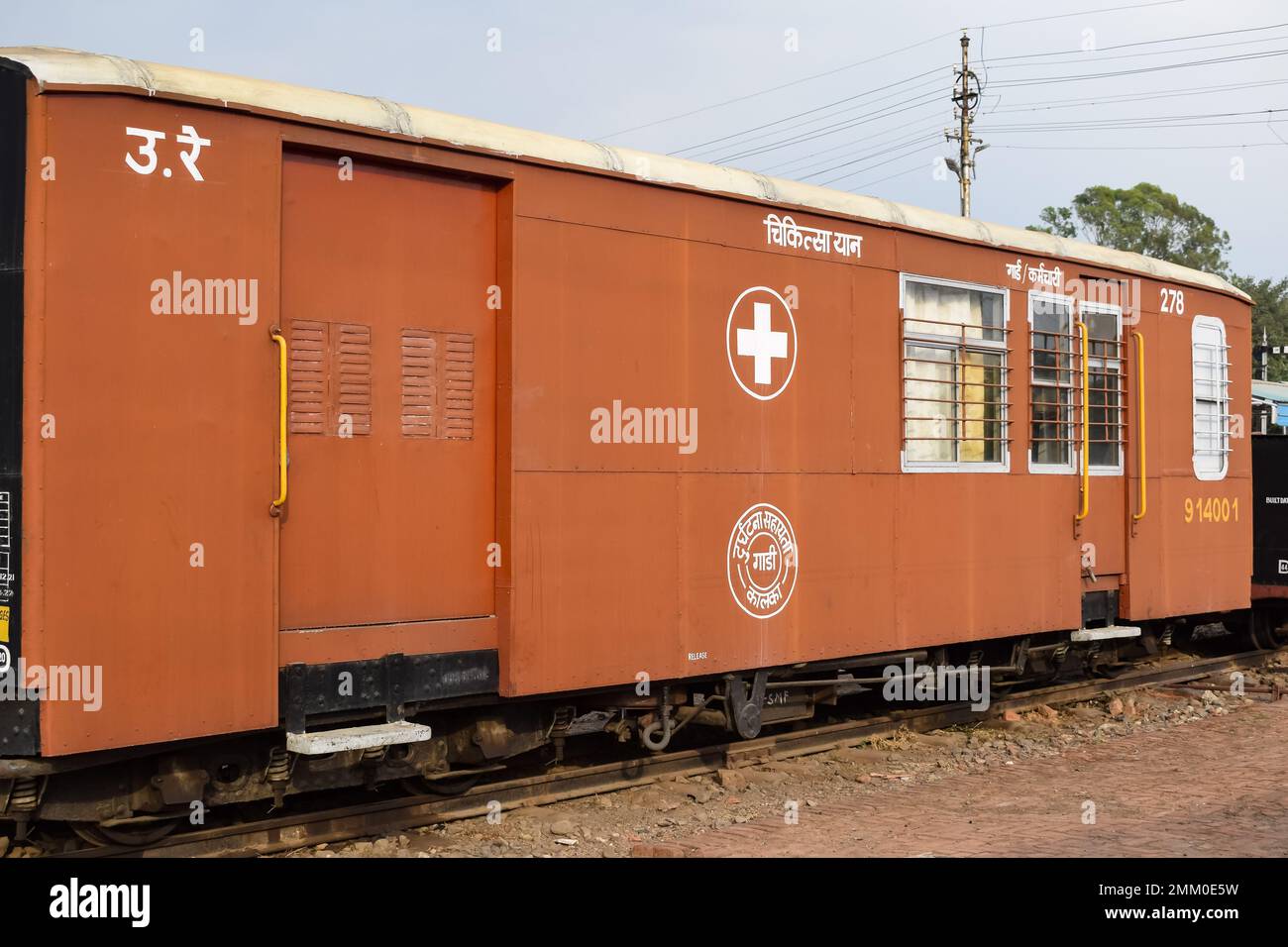View of Toy train coach from the middle of railway track during daytime