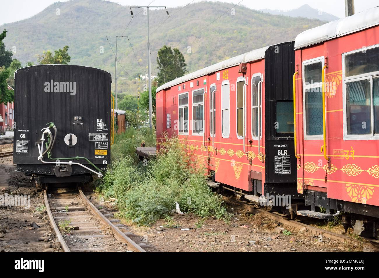 View of Toy train coach from the middle of railway track during daytime