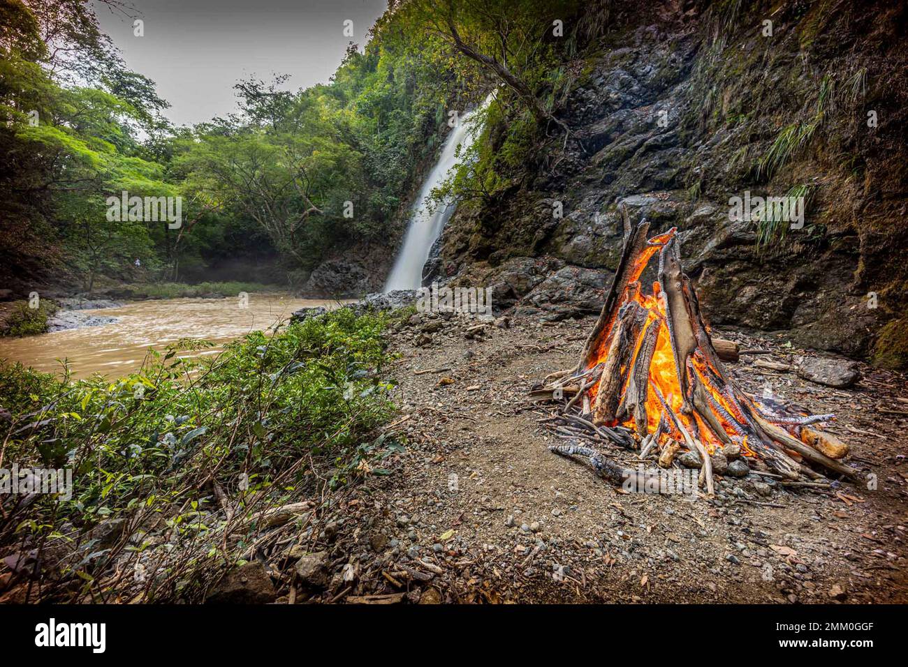 Camp fire on the beach at Santa Teresa a small town in Puntarenas Province, Costa Rica. Santa Teresa started as a remote fishing village, relying on a Stock Photo