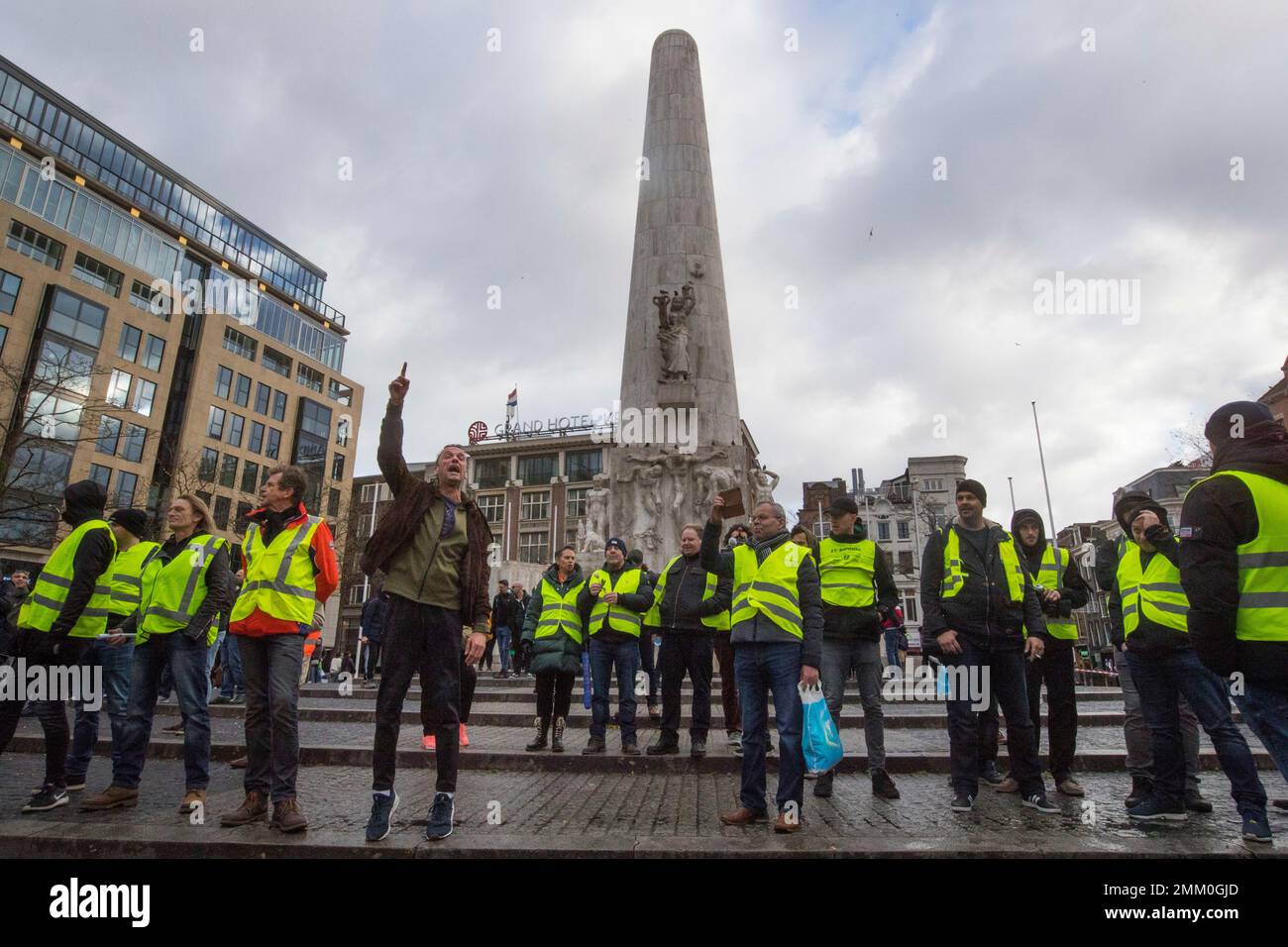 Demonstrators in yellow vest shout slogans in front of the National
