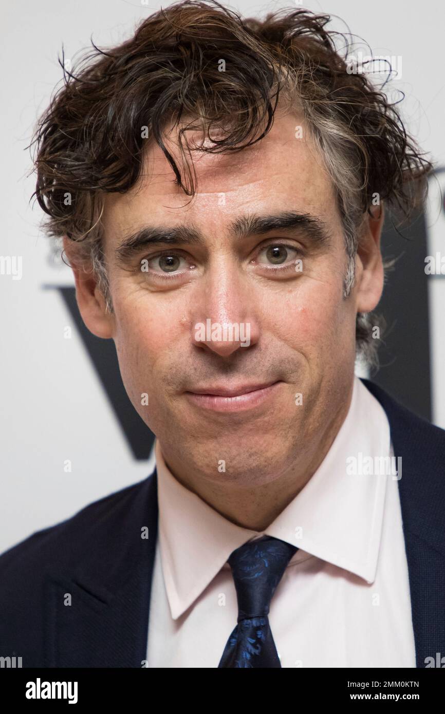 Actor Stephen Mangan poses for photographers upon arrival at the Women