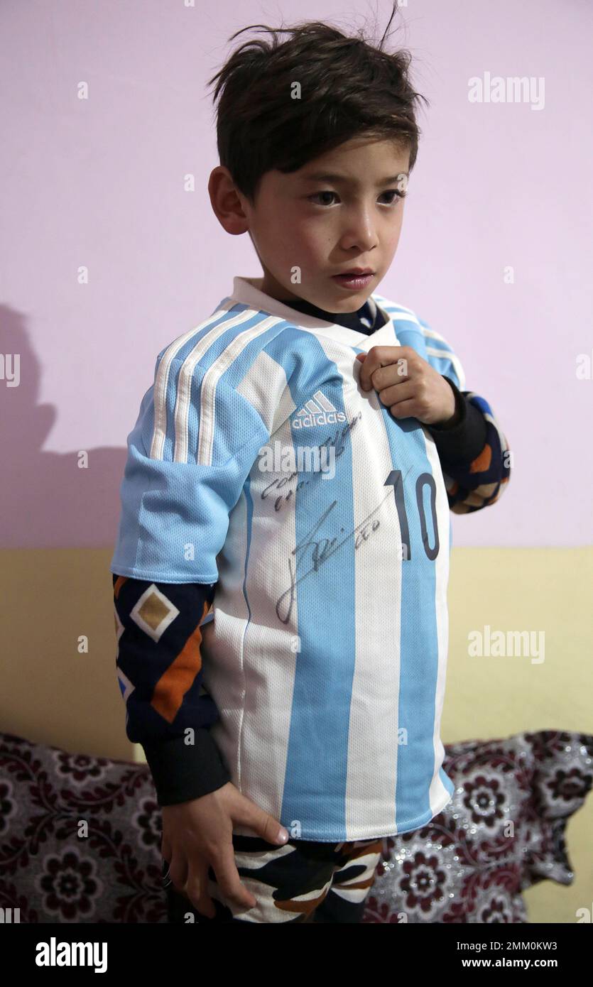Murtaza Ahmadi, a Lionel Messi fan, shows Lionel Messi's signature on a