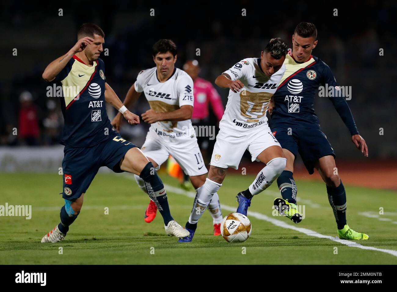 Pumas' Martin Rodriguez, second from right, dribbles the ball past America's  Guido Rodriguez, far left, and Andres Uribe, right, during a Mexico soccer  league first leg semifinals match in Mexico City, Thursday,