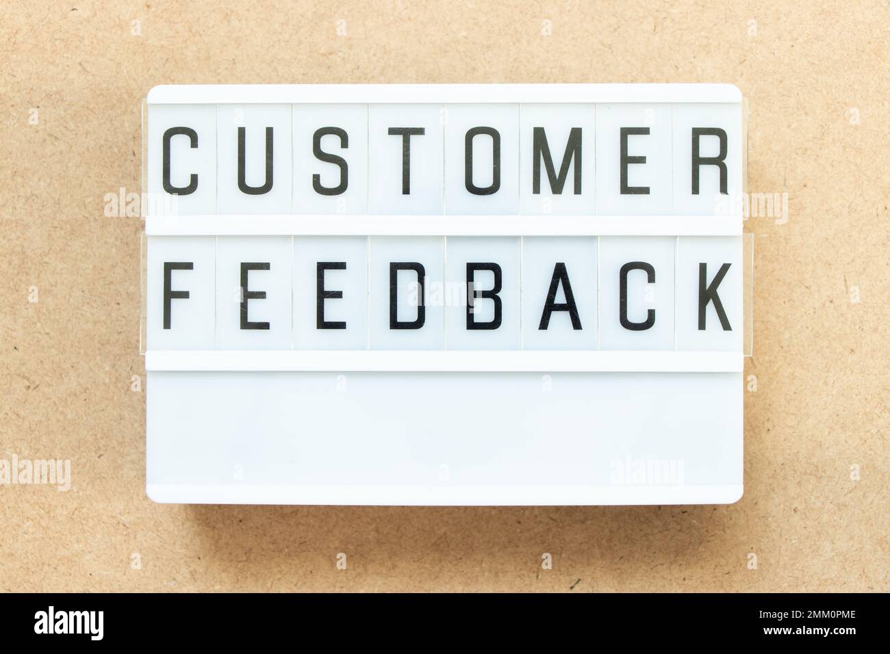 Lightbox with word customer feedback on wood background Stock Photo