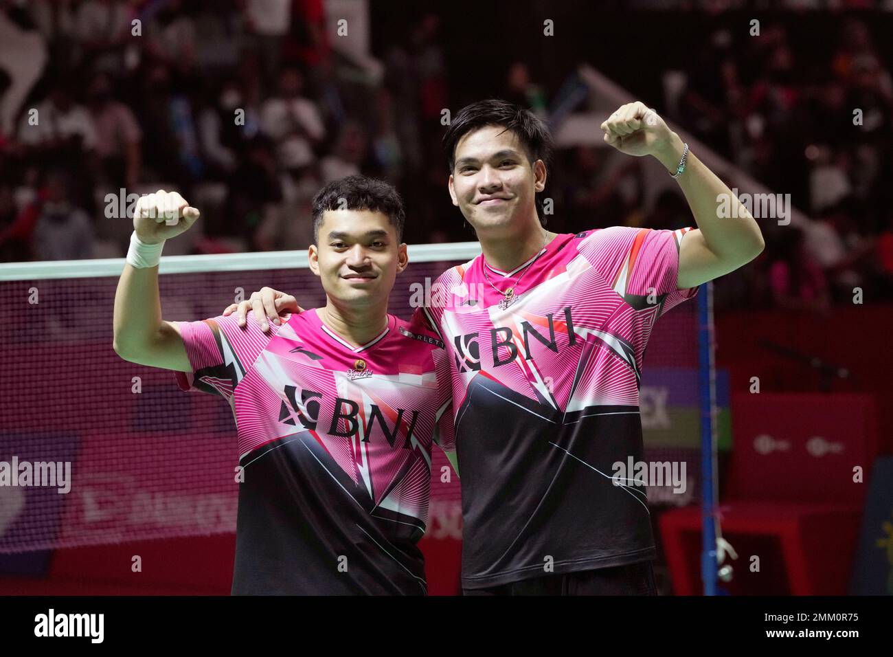 Indonesias Daniel Marthin, right, and Leo Rolly Carnando celebrate with their gold medals after defeating compatriots Pramudya Kusumawardana and Yeremia Rambitan in the mens doubles badminton final match at the 31st Southeast