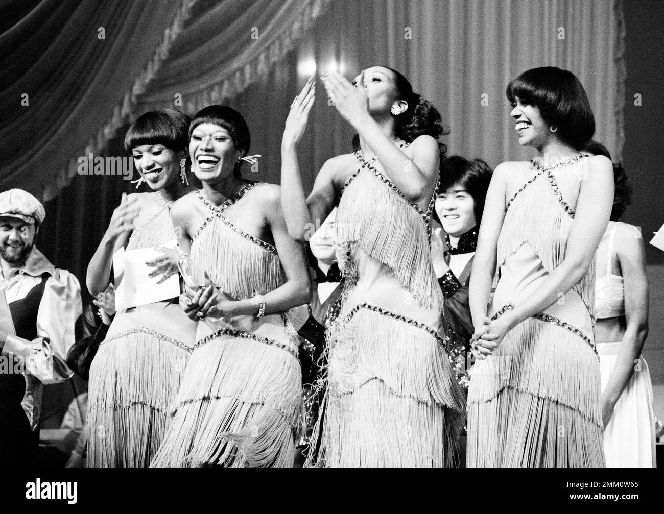 The Pointer Sisters, an American singing group, rejoice as they