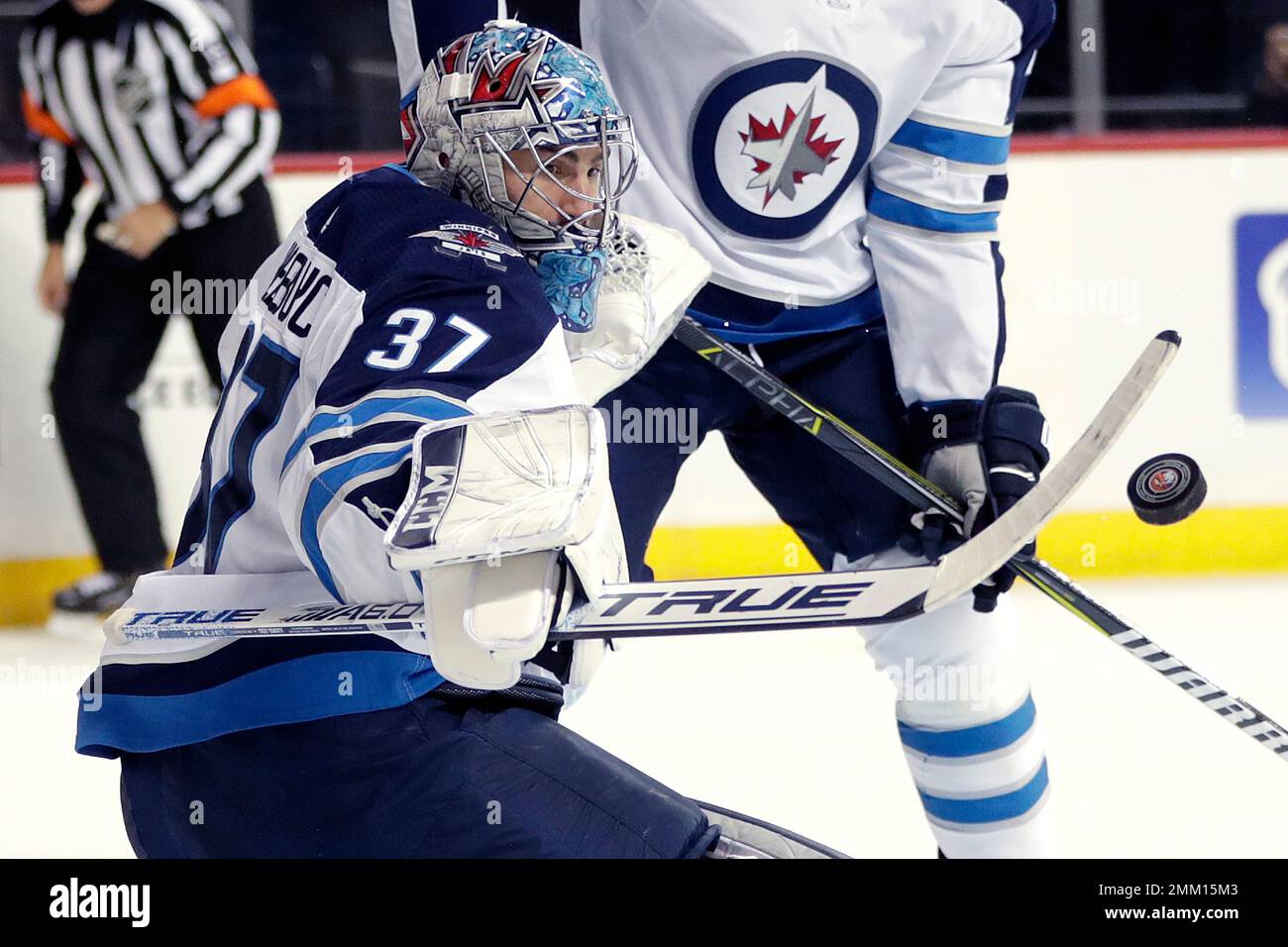 Connor Block Winnipeg Jets goaltender Connor Hellebuyck (37) blocks a shot from the ...