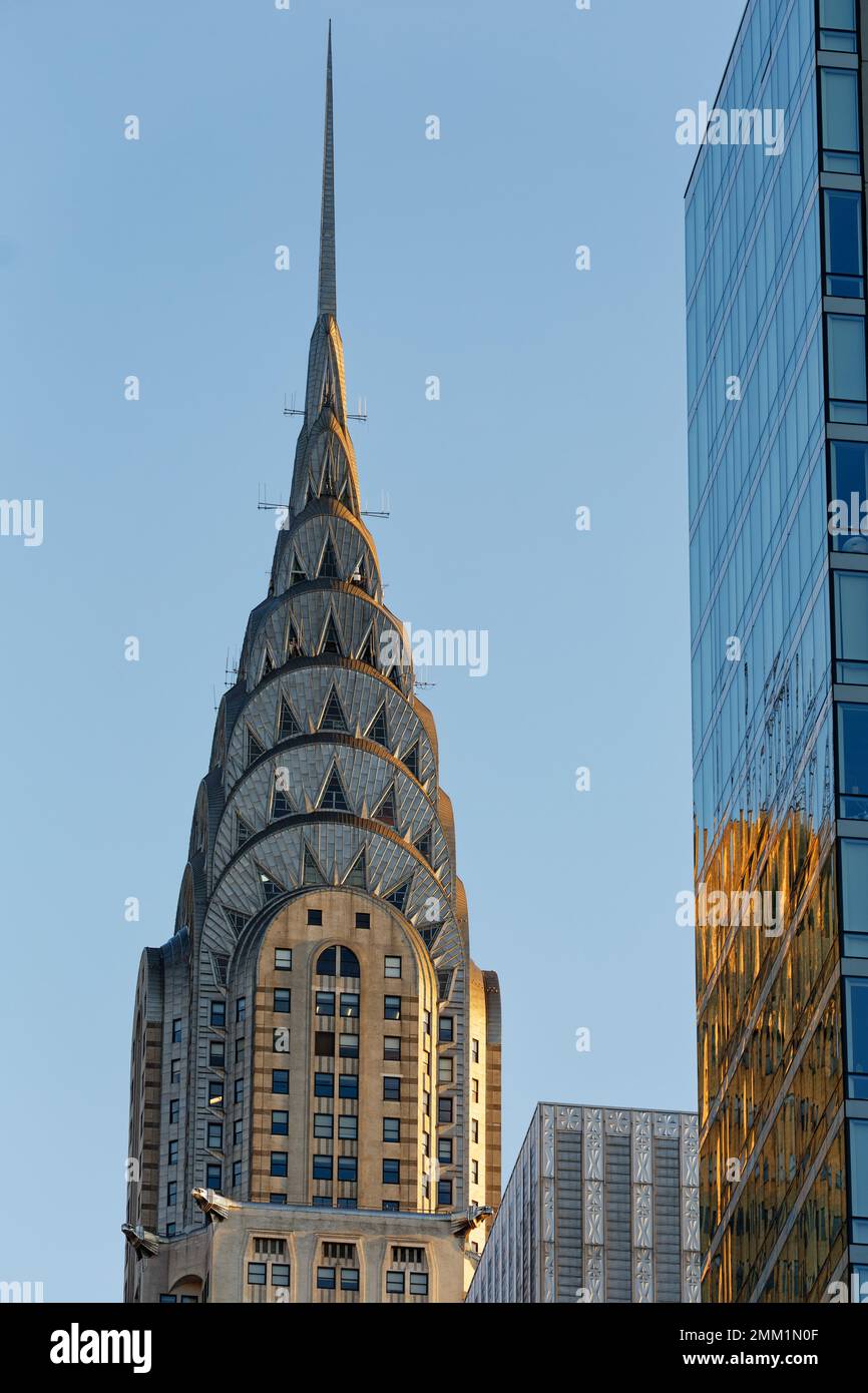 Early morning view of New York City landmark Chrysler Building; the iconic Art Deco spire is fringed in red from the sun. Stock Photo