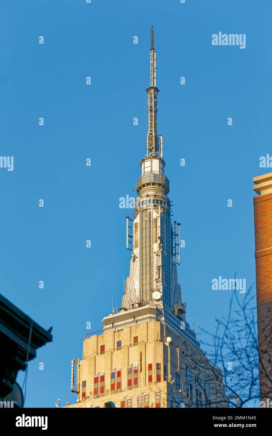 NYC: Empire State Building’s signature mast, originally conceived as a dirigible mooring mast, is now an observation deck and broadcast tower. Stock Photo