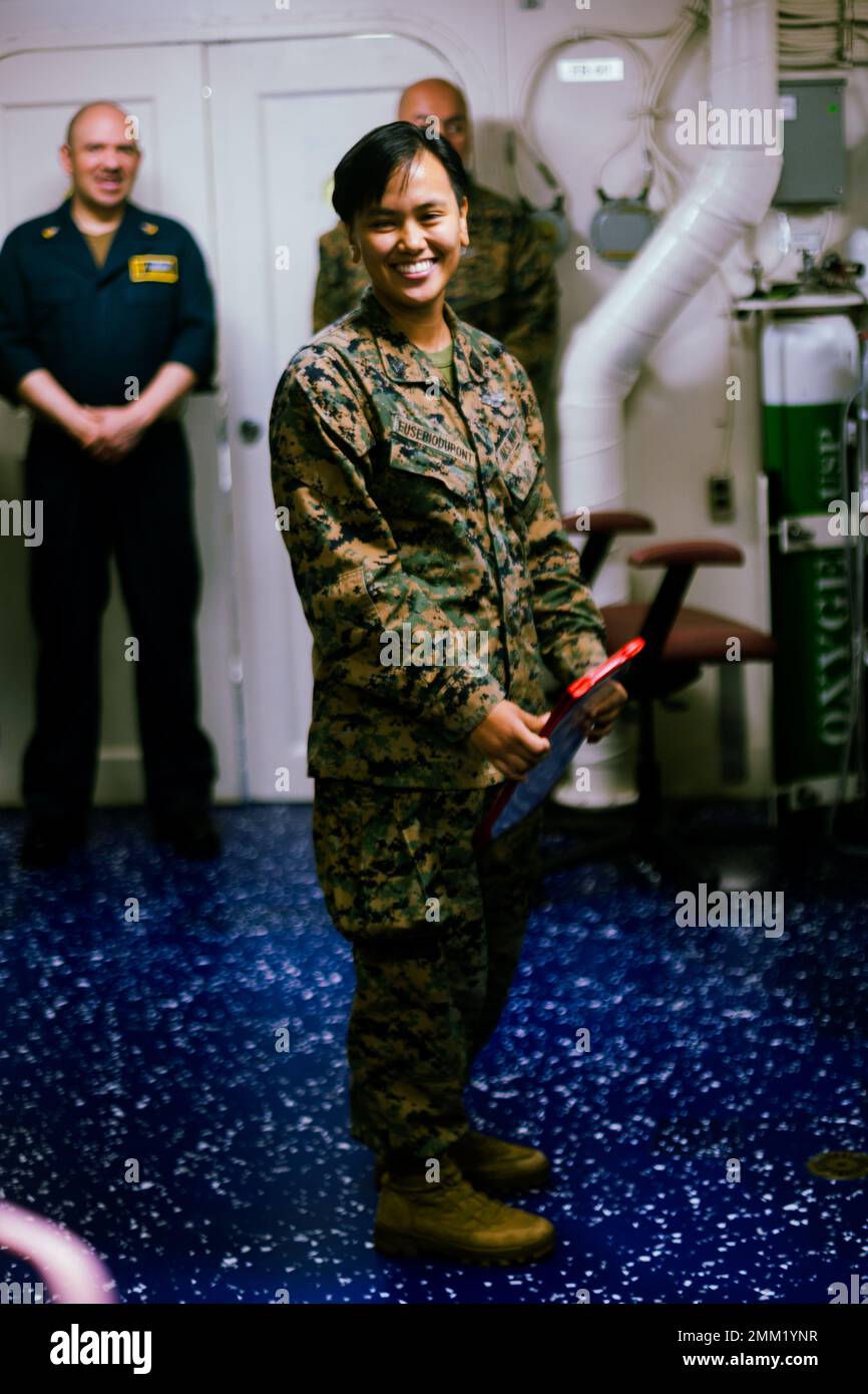 U.S. Navy hospital corpsman 2nd class Joelle Eusebiodupont, with CLB 31, 31st MEU, is congratulated on receiving her new rank during her promotion ceremony aboard Amphibious Assault Ship USS Tripoli (LHA-7), in the Philippine Sea, Sept. 13, 2022. The Meritorious Advancement Program recognizes sailors whose performance reflects a rank higher than their current station, and ensures they are allowed to reach their full potential. Stock Photo