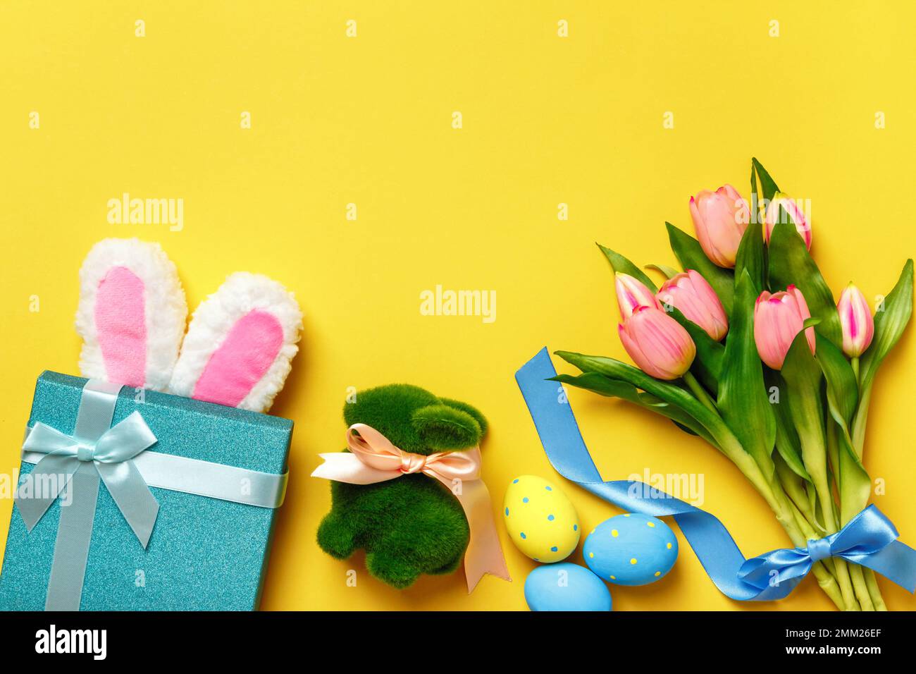 Easter composition. Holiday symbols on yellow background with copy space. Stock Photo