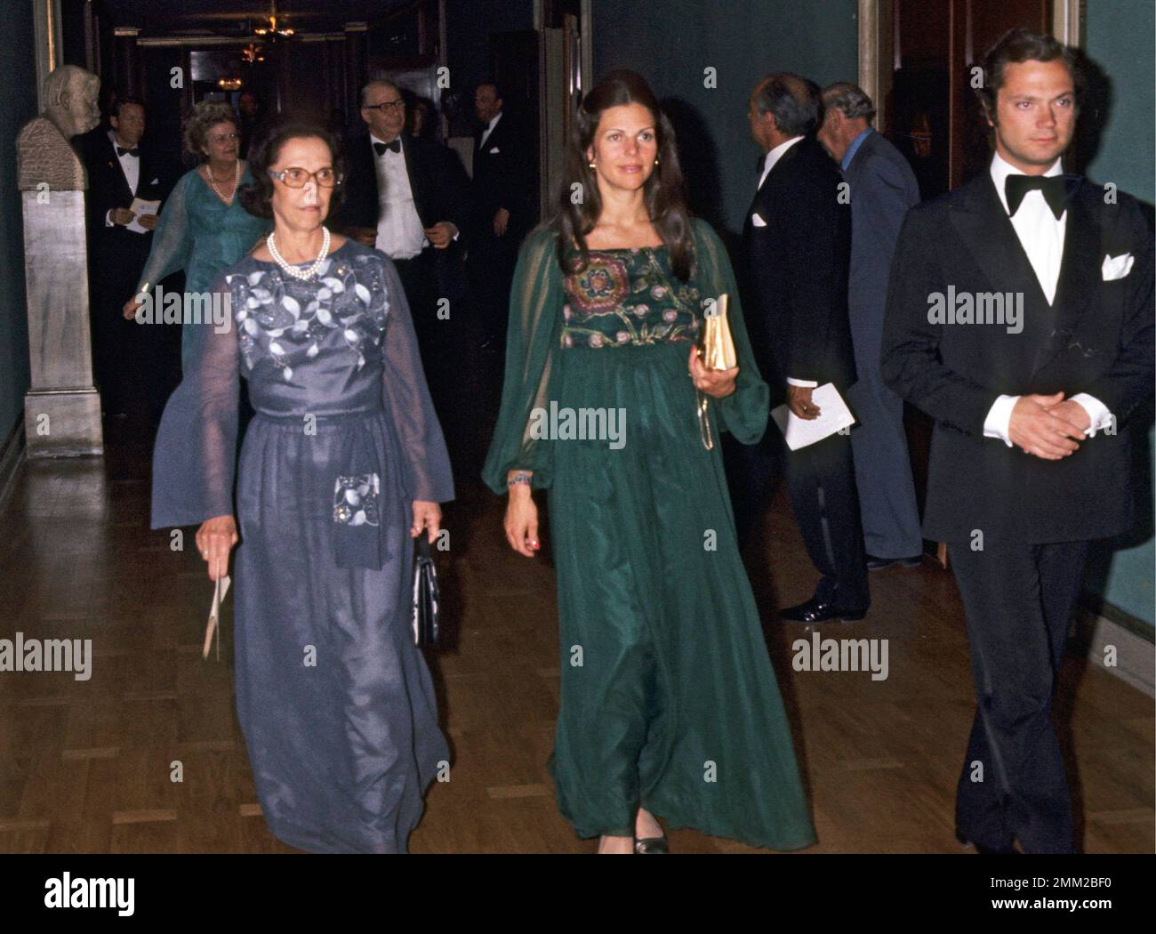The King Carl XVI Gustaf and Queen Silvia Renate Sommerlath at a consert at the Stockholm conserthall. On the left Queen Silvias mother Alice. 1977 Stock Photo