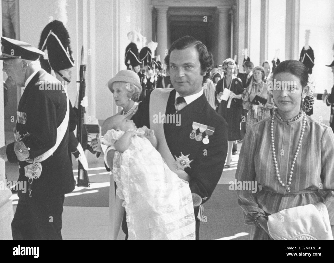 Carl XVI Gustaf, King of Sweden. Born 30 april 1946. Pictured with Queen Silvia and crown princess Victoria on the day of her being baptised 27 september 1977. Her full name is Victoria Ingrid Alice Désirée. Stock Photo