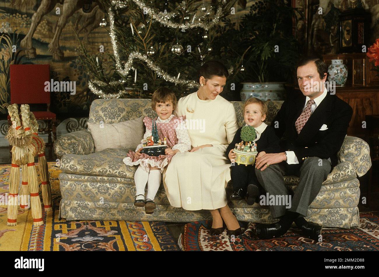 Carl XVI Gustaf, King of Sweden. Born 30 april 1946. Pictured with Queen Silvia and their daughter crown princess Victoria and prince Carl Philip in a christmas photosession december 1981. Stock Photo
