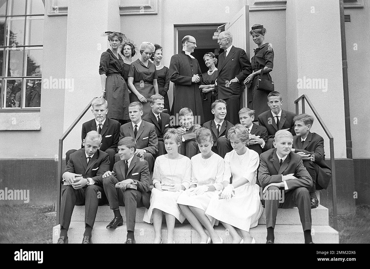 Carl XVI Gustaf, King of Sweden. Born 30 april 1946. Picture taken in connection with his confirmation 21 july 1962 at Borgholms church on the island of Öland. The swedish royal family attends the ceremony here the crown prince mother princess Sibylla and king Gustaf VI Adolf and his siblings Christina, Margaretha, Desirée and Birgitta. Queen Ingrid of Denmark is standing next to the priest. ref SC1020 Stock Photo