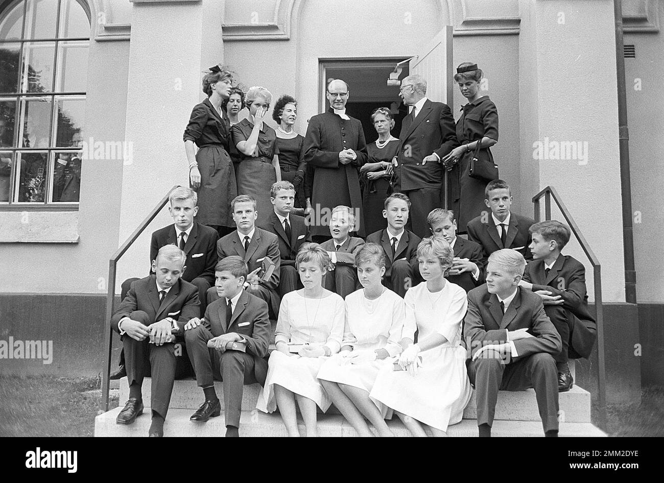 Carl XVI Gustaf, King of Sweden. Born 30 april 1946. Picture taken in connection with his confirmation 21 july 1962 at Borgholms church on the island of Öland. The swedish royal family attends the ceremony here the crown prince mother princess Sibylla and king Gustaf VI Adolf and his siblings Christina, Margaretha, Desirée and Birgitta. Queen Ingrid of Denmark is standing next to the priest. ref SC1020 Stock Photo