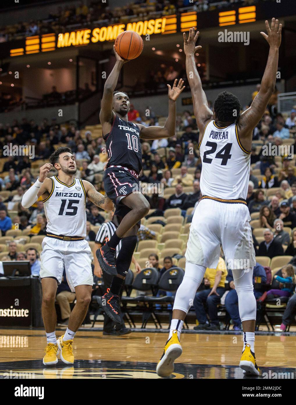 Temple's Shizz Alston Jr., center, shoots between Missouri's Kevin Puryear,  right, and Jordan Geist during the second half of an NCAA college basketball  game Tuesday, Nov. 27, 2018, in Columbia, Mo. Temple