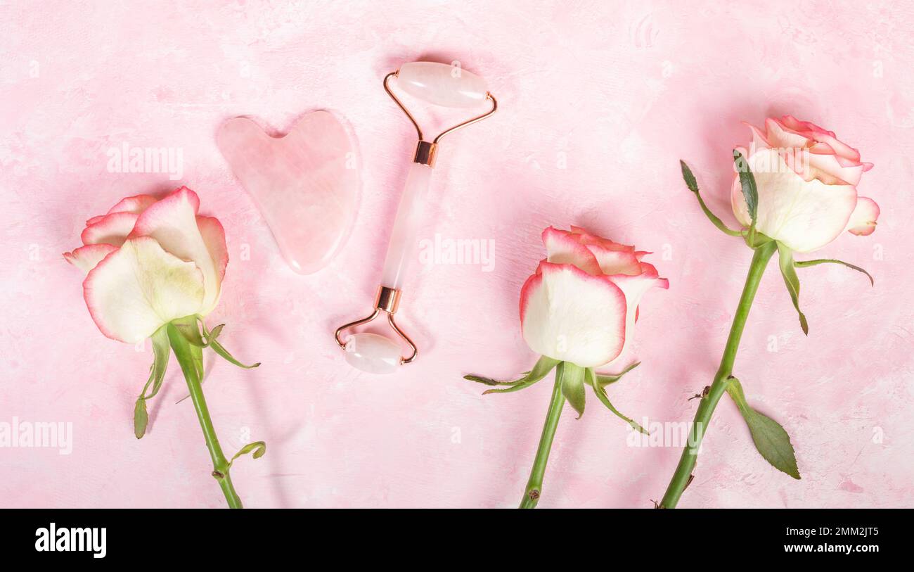 Arrangement of pink quartz stone Guasha scraper, roller massager for ...