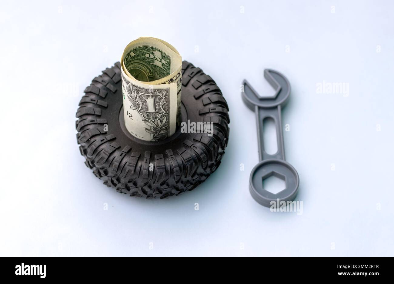 tire replacement change concept.black tires plastic wrench key dollar