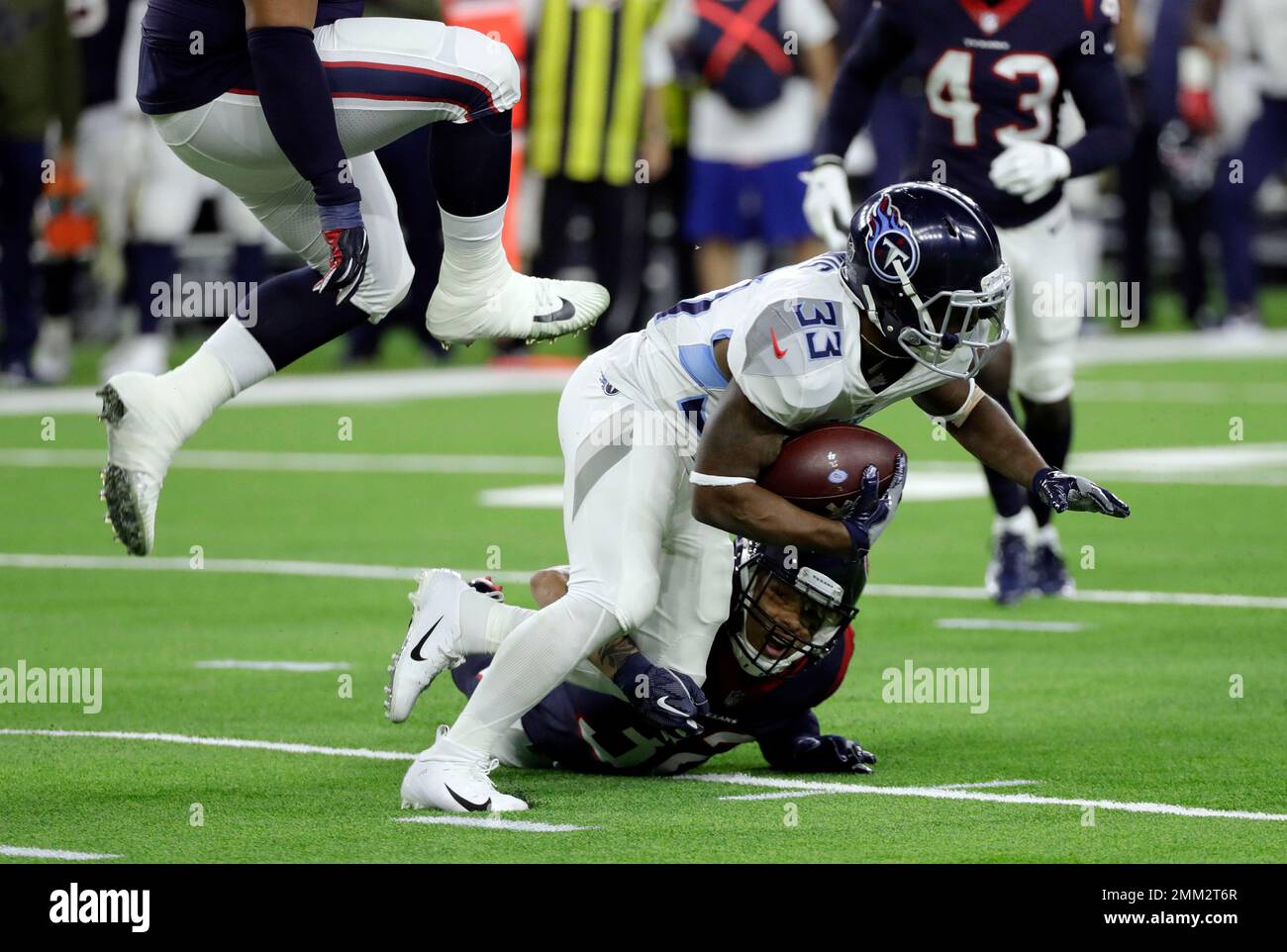 Tennessee Titans running back Dion Lewis (33) is hit by Houston Texans ...