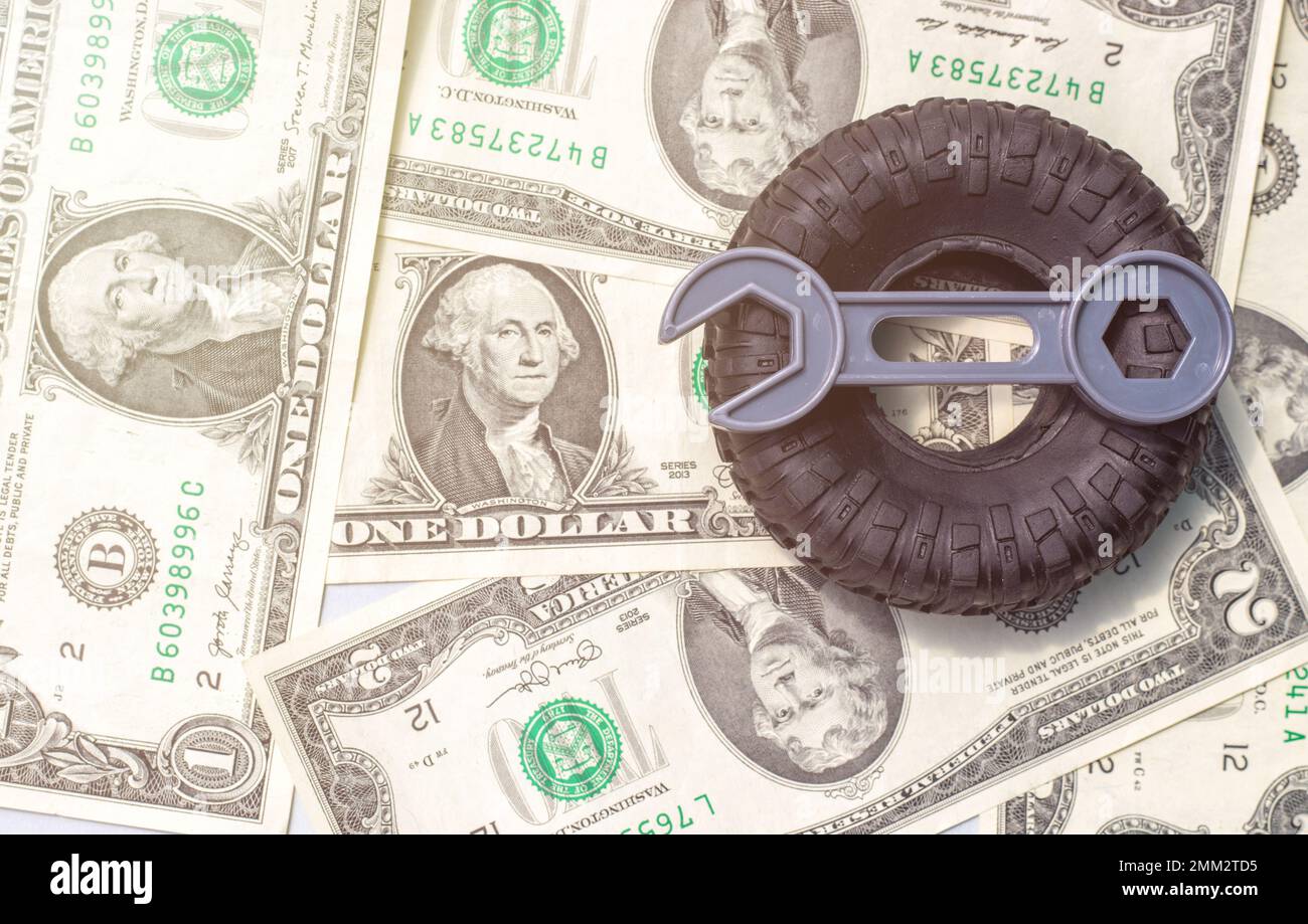 tire replacement change concept.black tires plastic wrench key dollar