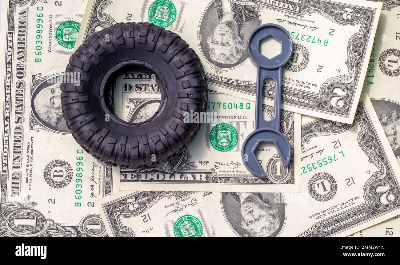 tire replacement change concept.black tires plastic wrench key dollar